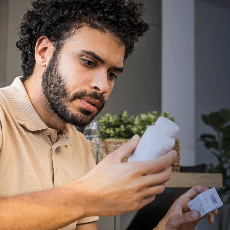 Man holds a prescription medication container