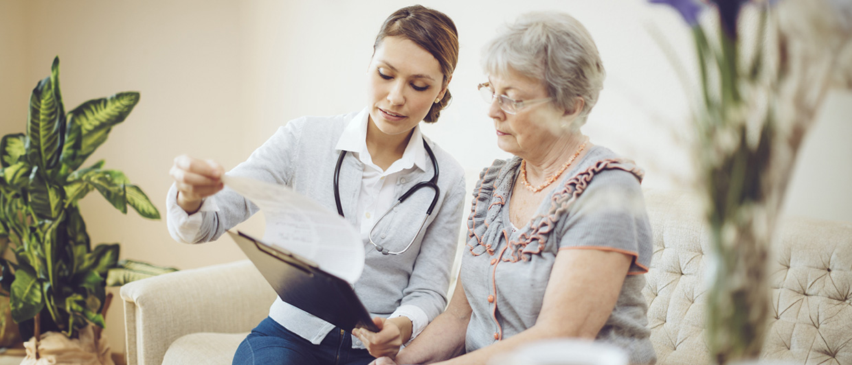 Doctor looking over chart with woman